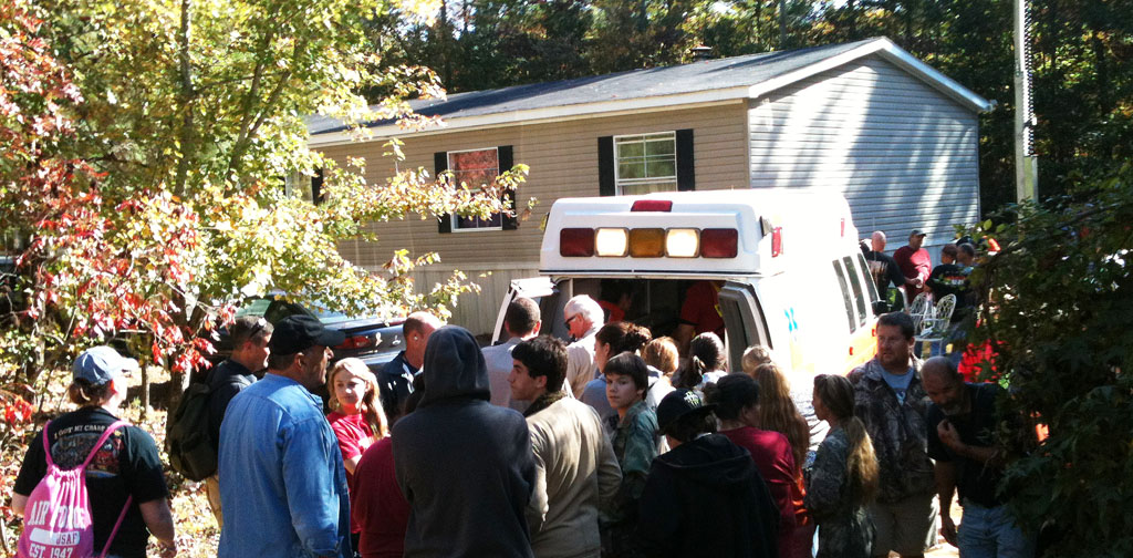 Family, friends and searchers gather around RPS ambulance while Kyle Camp gets his initial check out
