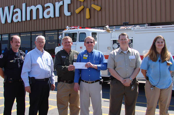 Ken Farr presents Phillip Weaver with $1000 check from Walmart Foundation